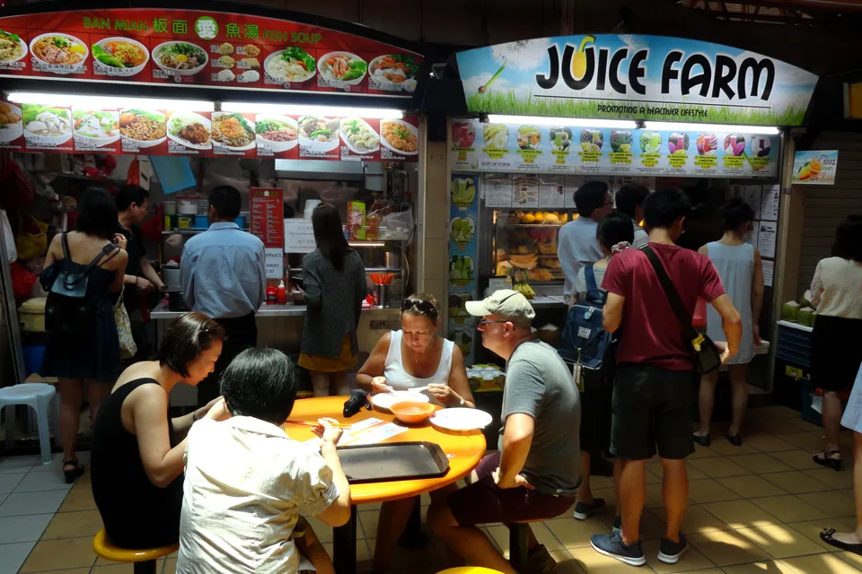 Maxwell Food Centre from the street corner in Chinatown, a two-storey hawker centre with a pale facade