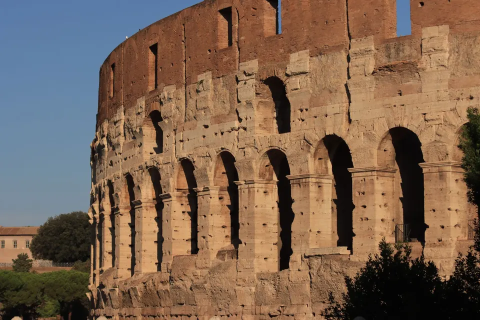 The weathered stone arches of the Colosseum in Rome
