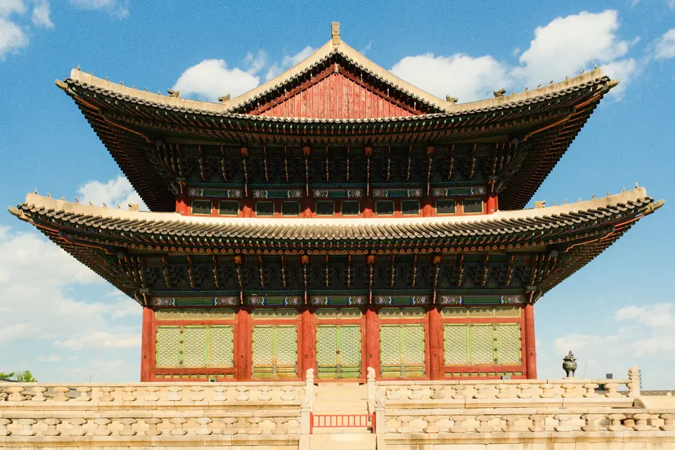 Geunjeongjeon, the two-tiered throne hall of Gyeongbokgung Palace in Seoul, under a clear blue sky