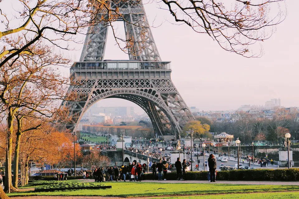 The Eiffel Tower seen from the Trocadéro gardens, framed by autumn trees