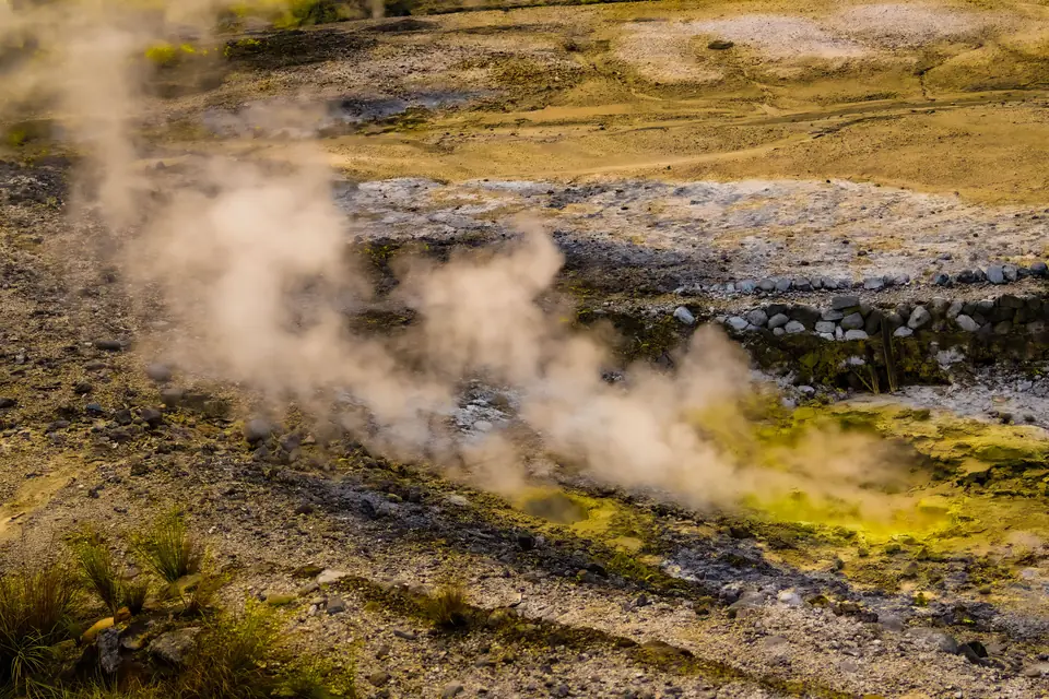 Steam rising from hot spring vents across a geothermal valley in Taipei