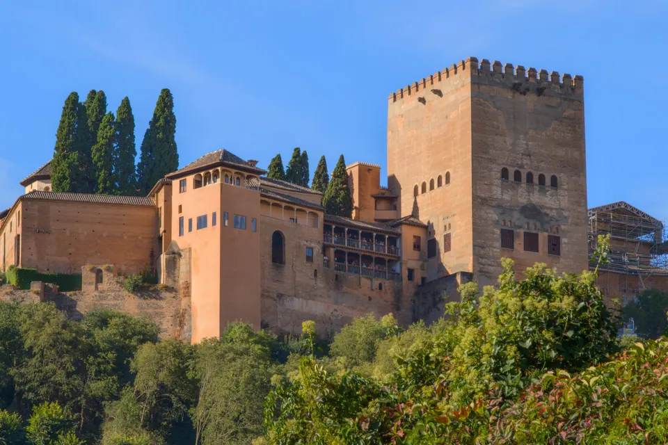 The Alhambra's walls and towers above the trees of Granada