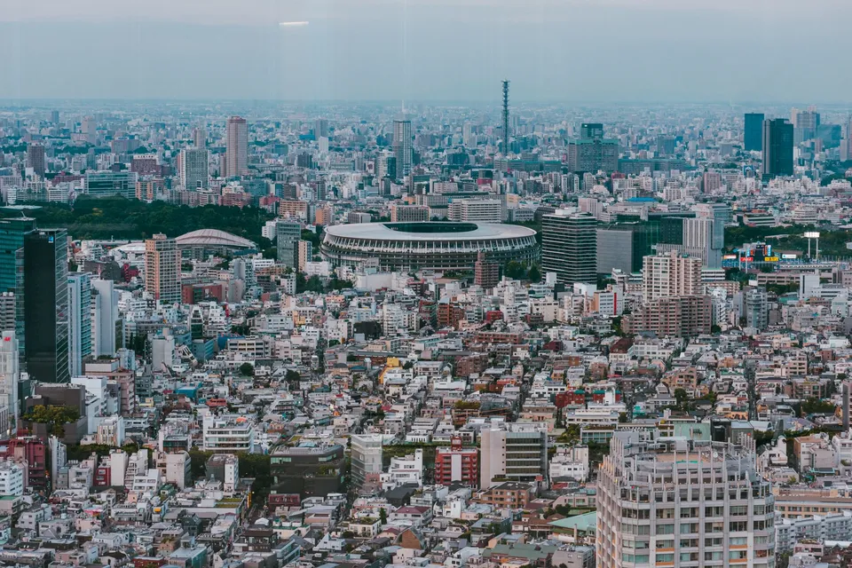 Shibuya at dusk, with the towers around the crossing and the sky turning orange. This is the district, not the observation deck