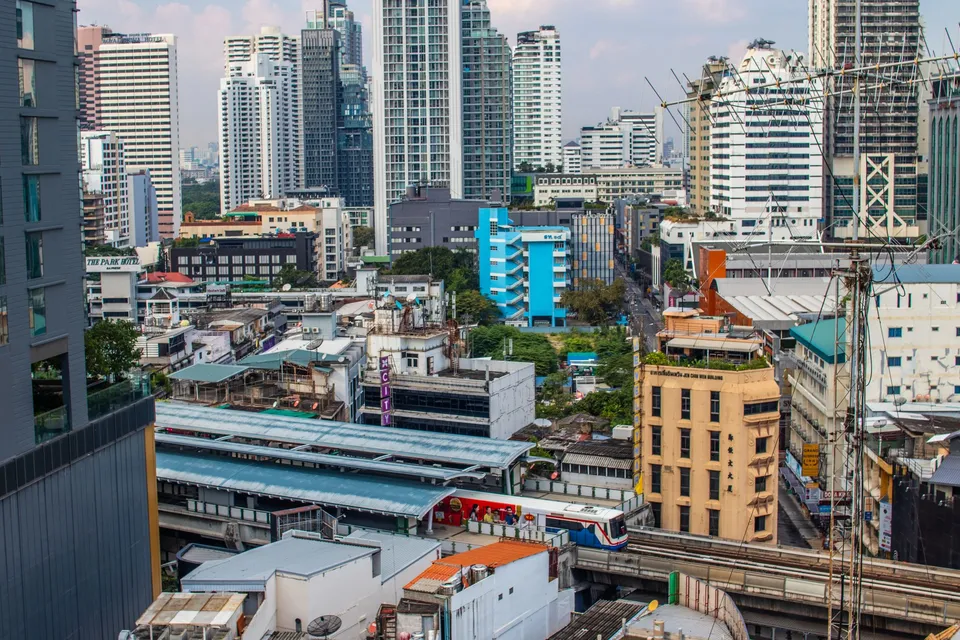 Towers and rooftops of Bangkok above a Skytrain station